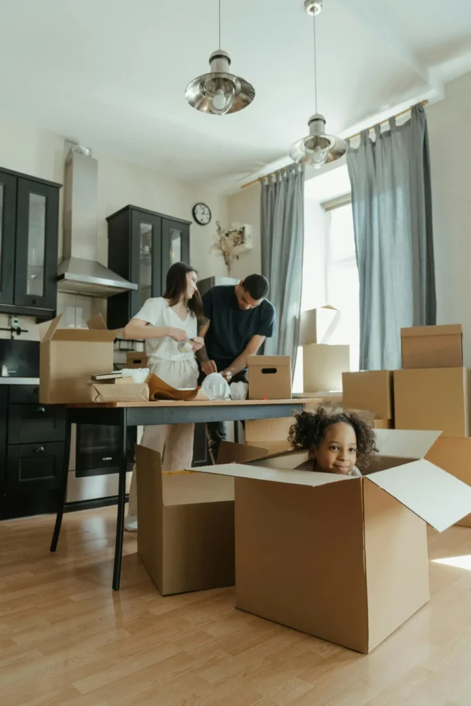 Family packing and unpacking boxes during a home move with organized packing system